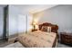 Bedroom with a queen-size bed, classic wood furniture, gray walls and gray wood-look floors at 1733 N Michael Way, Las Vegas, NV 89108