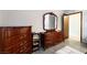 Bedroom showcasing dark wood furniture, neutral walls, and ample storage in a cozy space at 1733 N Michael Way, Las Vegas, NV 89108
