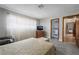 Bedroom featuring neutral decor, laminate floors, a comfortable bed, a chair and a wall-mounted TV at 1733 N Michael Way, Las Vegas, NV 89108
