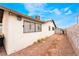 Side of property featuring desert landscaping and secure windows at 1733 N Michael Way, Las Vegas, NV 89108