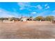 Wide angle shot of a modest single story home with desert landscaping and mature foliage at 1733 N Michael Way, Las Vegas, NV 89108