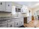 An outdated kitchen featuring white cabinets with vintage hardware and tile floor at 1733 N Michael Way, Las Vegas, NV 89108