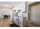 An outdated kitchen featuring white appliances, tile floor, and an arched entryway at 1733 N Michael Way, Las Vegas, NV 89108
