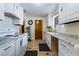 An outdated kitchen with tile floor, white cabinets, and vintage hardware at 1733 N Michael Way, Las Vegas, NV 89108