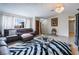 Cozy living room with a leather sectional sofa, zebra-print rug, and stone accent wall at 1733 N Michael Way, Las Vegas, NV 89108