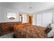A main bedroom featuring an ornate bed frame, wood look floors, and neutral paint at 1733 N Michael Way, Las Vegas, NV 89108