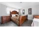 A main bedroom featuring an ornate bed frame, wood look floors, and neutral paint at 1733 N Michael Way, Las Vegas, NV 89108