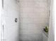 Modern shower featuring white subway tiles with grey accents, a shower head, and toiletry shelf at 1733 N Michael Way, Las Vegas, NV 89108