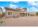 Side view of backyard showcasing covered patio, grill, rock landscaping, and well-kept lawn at 1893 Donnington Ct, Las Vegas, NV 89123