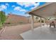 Spacious backyard with patio area, rock landscaping, and privacy wall at 1893 Donnington Ct, Las Vegas, NV 89123