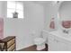 Bright bathroom with a white toilet, sink and a window at 1893 Donnington Ct, Las Vegas, NV 89123