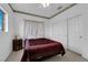 Bedroom boasts a window, closet, and patterned wallpaper border near the ceiling at 1893 Donnington Ct, Las Vegas, NV 89123