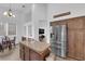 A kitchen with stainless steel appliances, including a refrigerator and gas stovetop, and an island at 1893 Donnington Ct, Las Vegas, NV 89123