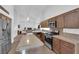 Gourmet kitchen featuring granite countertops, stainless steel appliances, and a breakfast bar, perfect for entertaining at 1893 Donnington Ct, Las Vegas, NV 89123