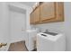 Functional laundry room is equipped with a washer, dryer, and overhead cabinets at 1893 Donnington Ct, Las Vegas, NV 89123