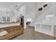 A cozy living room area with a kitchen view and a staircase in the background at 1893 Donnington Ct, Las Vegas, NV 89123