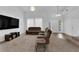 Spacious living room featuring plush carpeting and abundant natural light at 1893 Donnington Ct, Las Vegas, NV 89123
