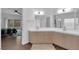 Bright main bathroom with double sinks and view into the main bedroom at 1893 Donnington Ct, Las Vegas, NV 89123