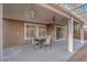 Comfortable covered patio with ceiling fan, table, chairs, and door to backyard at 1893 Donnington Ct, Las Vegas, NV 89123