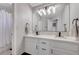 Modern bathroom featuring double sinks, white cabinets, and a large mirror at 2016 Catalina Marie Ave, Henderson, NV 89074