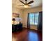 This bedroom showcases hardwood floors, a ceiling fan, and natural light from a large window at 2016 Catalina Marie Ave, Henderson, NV 89074