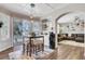 Charming dining area with a view of the pool, seating for four, and modern light fixture at 2016 Catalina Marie Ave, Henderson, NV 89074