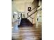 Inviting foyer featuring a staircase with dark wood trim and carpet runner, with an open view to the living areas at 2016 Catalina Marie Ave, Henderson, NV 89074