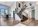 Welcoming foyer featuring a staircase, dining area, and modern design elements at 2016 Catalina Marie Ave, Henderson, NV 89074