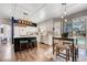 Modern kitchen with granite countertops, white cabinetry, an island with seating, and stainless steel appliances at 2016 Catalina Marie Ave, Henderson, NV 89074