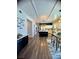 Open-concept kitchen boasts a large island, white cabinetry, and wood floors with a view to the dining area at 2016 Catalina Marie Ave, Henderson, NV 89074