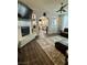 Comfortable living room boasts a fireplace, a ceiling fan, and seamlessly connects to the kitchen area at 2016 Catalina Marie Ave, Henderson, NV 89074