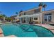 Backyard pool with tanning ledge, mature landscaping, and covered patio area at 2016 Catalina Marie Ave, Henderson, NV 89074