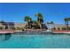 Inviting pool area with palm trees, water features, and lush landscaping at 2016 Catalina Marie Ave, Henderson, NV 89074