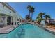 Beautiful pool area with palm trees, lush landscaping, and outdoor features at 2016 Catalina Marie Ave, Henderson, NV 89074