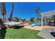 Backyard oasis featuring a pool, hammock, covered patio, and lush landscaping at 2016 Catalina Marie Ave, Henderson, NV 89074