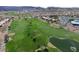 Stunning aerial view of the golf course with mature trees and a tranquil lake at 2158 Indigo Creek Ave, Henderson, NV 89012