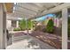 Shaded patio area with desert landscaping creates a serene backyard space at 2158 Indigo Creek Ave, Henderson, NV 89012