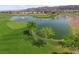 Scenic golf course view featuring lush greens and a serene pond with fountains at 2158 Indigo Creek Ave, Henderson, NV 89012