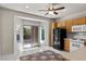 Bright kitchen with white tile floors and sliding glass doors to the backyard patio at 2158 Indigo Creek Ave, Henderson, NV 89012