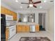 Spacious kitchen with white appliances, tile floors, and wood cabinetry at 2158 Indigo Creek Ave, Henderson, NV 89012