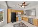 Open kitchen with white appliances, tile floors, and wood cabinetry at 2158 Indigo Creek Ave, Henderson, NV 89012