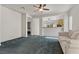 Inviting living room with a ceiling fan and an open view to the kitchen at 2158 Indigo Creek Ave, Henderson, NV 89012