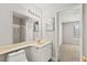 Bright bathroom with vanity, mirror, and view to bedroom with natural light at 2200 S Fort Apache Rd # 1033, Las Vegas, NV 89117