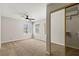 Bedroom with carpet, ceiling fan, two windows, and a mirrored closet at 2200 S Fort Apache Rd # 1033, Las Vegas, NV 89117