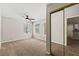 Bedroom featuring neutral walls, carpet, ceiling fan, and a mirrored closet at 2200 S Fort Apache Rd # 1033, Las Vegas, NV 89117