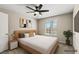 Cozy bedroom features a ceiling fan, a window and a large TV mounted on the wall at 2200 S Fort Apache Rd # 1033, Las Vegas, NV 89117