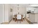 Dining room showcases a modern chandelier and a wooden table with white upholstered chairs at 2200 S Fort Apache Rd # 1033, Las Vegas, NV 89117