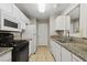 Updated kitchen with granite countertops, white cabinetry, and stainless steel appliances at 2200 S Fort Apache Rd # 1033, Las Vegas, NV 89117