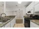 Bright kitchen featuring granite countertops, stainless steel sink, and white cabinetry at 2200 S Fort Apache Rd # 1033, Las Vegas, NV 89117
