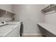Convenient laundry room with washer, dryer, shelving, and tile flooring at 2200 S Fort Apache Rd # 1033, Las Vegas, NV 89117